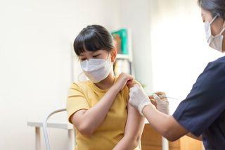 Person being vaccinated by a medical practitioner